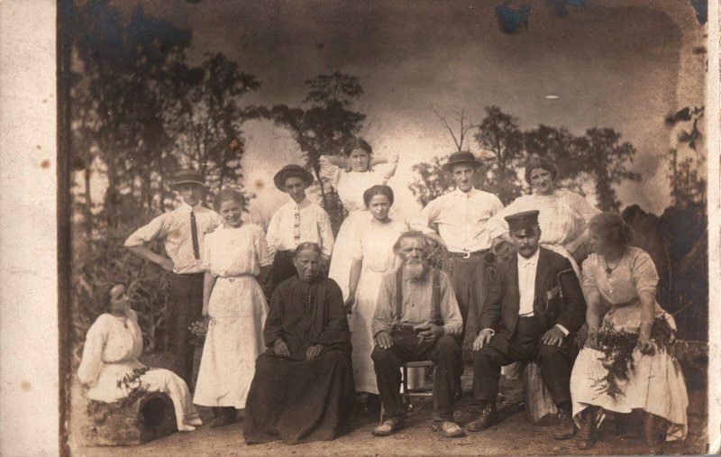 VINTAGE POSTCARD GROUP OF PEOPLE IN STAGED PHOTO ON RPPC SOME RUST ON REAR