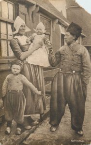 Culture & ethnicity Volendam traditional costumes family joy scene