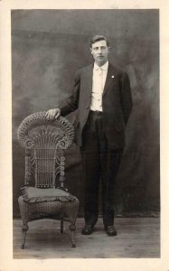 RPPC,  Studio Portrait MAN In SUIT With Hand On Wicker Chair  ca1910's Postcard