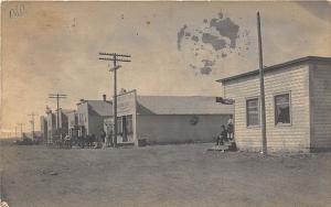 Sharlow ND Dirt Street Storefronts Horse & Wagons RPPC Postcard