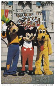 Goofy, Mickey Mouse, and Pluto Pose with One of the Entertainment Groups, DIS...