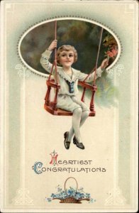 Congratulations Young Boy Swinging in Chair Swing c1910 Gel Vintage Postcard