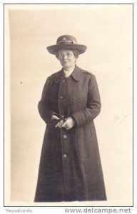 RP; Senior woman in hat and coat, holding gloves, 10-20s