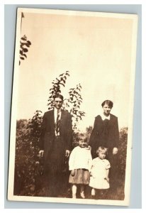 Vintage Early 1920's RPPC Photo of Family of Four in Front of Bushes