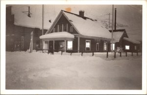 Real Photo Postcard Snow Covered House Building Next to Drug Store in Alaska