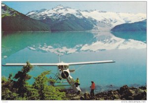 Float Airplane on Lake, Mountains Reflected in Lake, British Columbia, Canada...