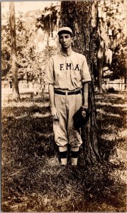 Real Photo Postcard F.M.A. Baseball Player Wearing Uniform in a Park