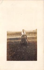 Child on toy car Child, People Photo 1912 crease left top corner