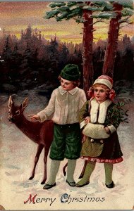 c1910 MERRY CHRISTMAS VICTORIAN CHILDREN WITH DEER AND SNOW POSTCARD 14-59 