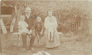 Social history vintage family photo postcard parents children visible damage