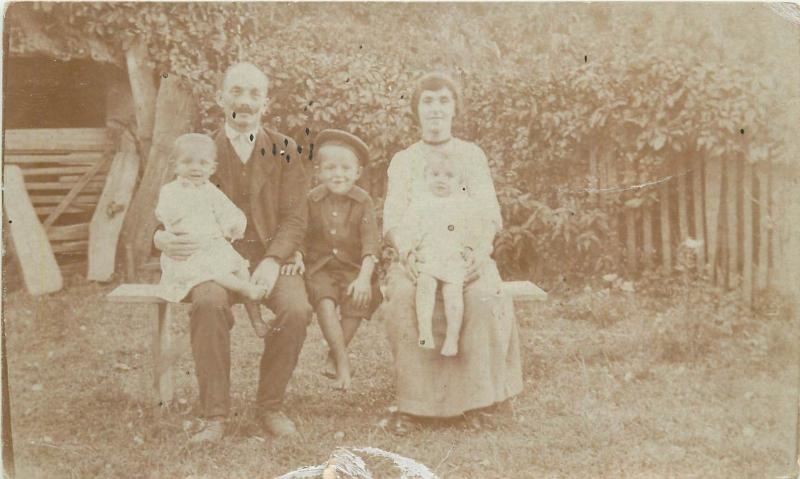 Social history vintage family photo postcard parents children visible damage