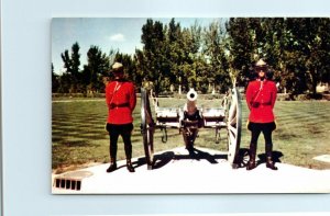 M-25730 Royal Canadian Mounted Police beside cannon of the Barracks Regina Ca...