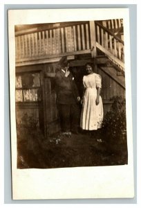 Vintage 1910's RPPC Postcard Photo of Man and Woman Outside in Front of Stairs