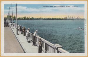 Miami, FLA., Old men & children fishing from the causeway - 1935