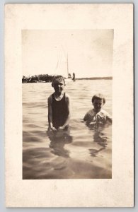 RPPC Children Wading in the Lake Sailboat and Pier in Distance Postcard I21