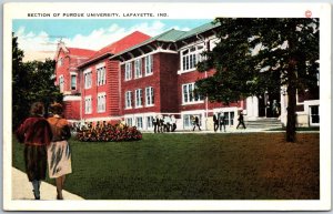 VINTAGE POSTCARD WOMEN WALK PAST SECTION OF PURDUE UNIVERSITY LAFAYETTE INDIANA