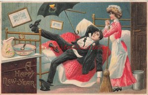 New Year, Man laying on bed with women over him, Umbrella, Embossed