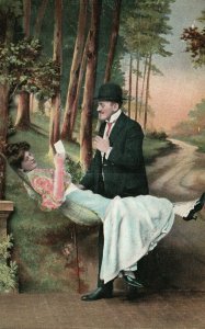 Vintage Postcard 1910s Woman Laying on Hammock Reading Letter with Man Listening