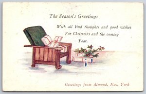 Almond New York Christmas~Gifts On Chair~Holly~Season's Greeting~1920s Postcard