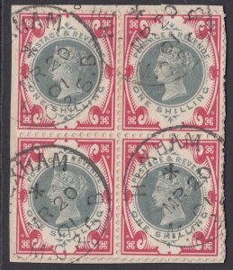 SG 214 1/- green & carmine. Very fine used block on 4 on small piece cancelled..