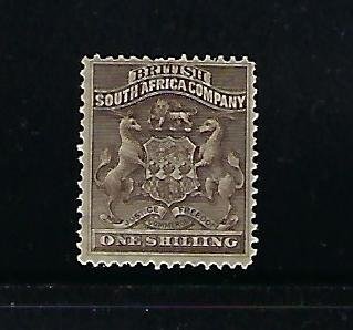 RHODESIA SCOTT #9 1890-95 COAT OF ARMS 1SH (GREY BROWN)  - MINT HINGED