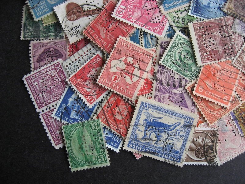 Worldwide perfins, 100 from various countries. Duplicates?, mixed condition. 