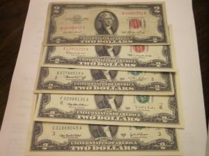 5 various issued dates of two dollar bills