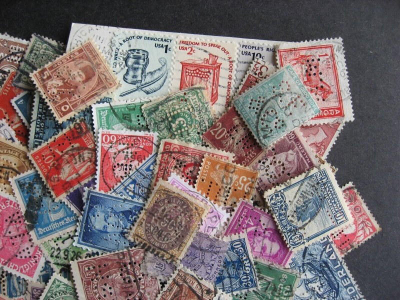 Worldwide perfins, 100 from various countries. Duplicates?, mixed condition. 