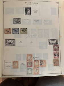 Collection of classic Netherlands Indies stamps on old Scott pages