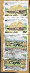 Laos #1247  used stamps on cut corner with post marks.