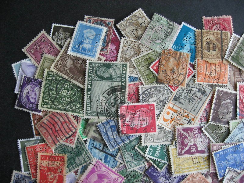 Worldwide perfins, 200 from various countries. Duplicates?, mixed condition.