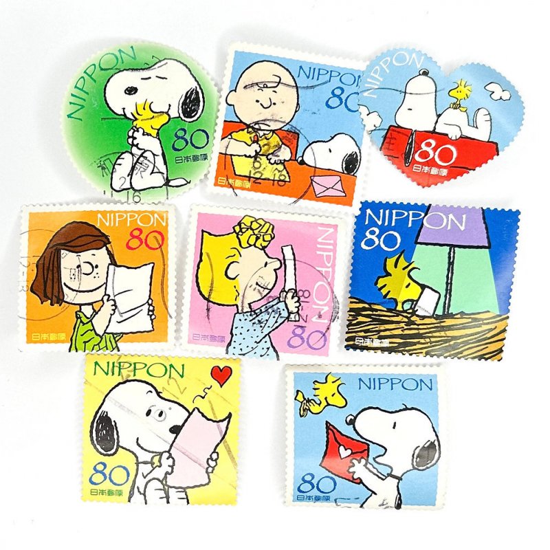 7 x Peanuts Snoopy Japanese used (larger) postage stamps - off paper - Japan