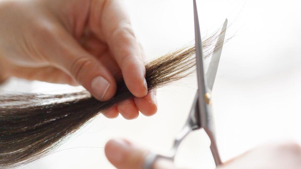 A woman getting her hair trimmed