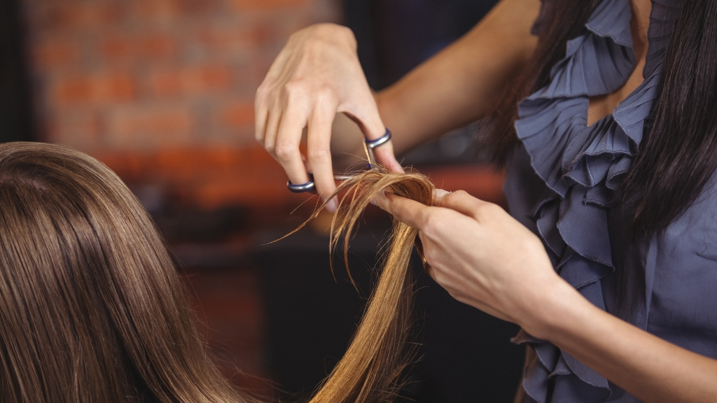 Hairdresser clipping a woman's hair