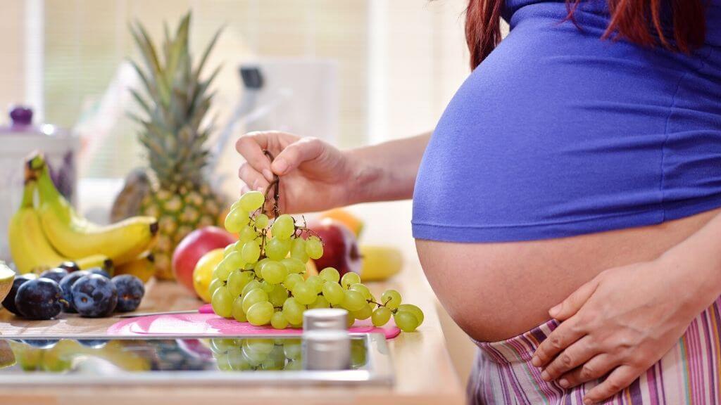 Pregnant woman having fruit