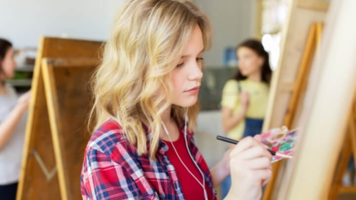 A young teenager concentrated on her art work