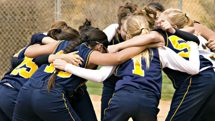 A girls sports team members in a huddle