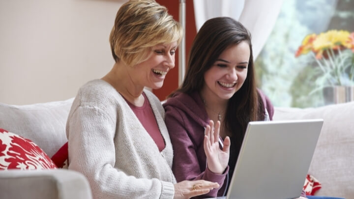 A teenager with her mom talking on a video call