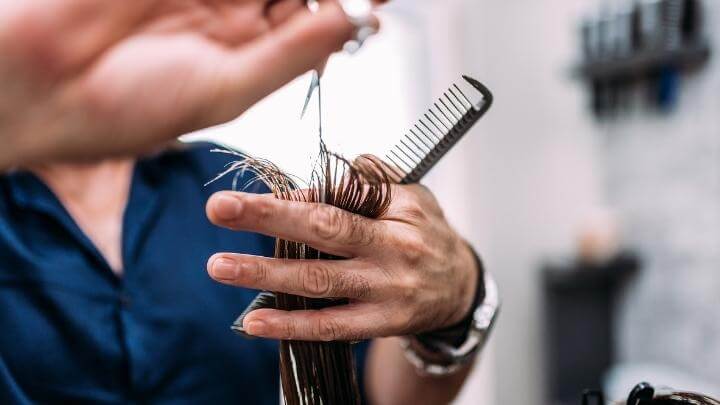 Woman getting a trim at the hair dresser