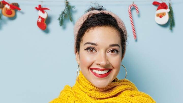 A woman wearing a poofy headband for holidays