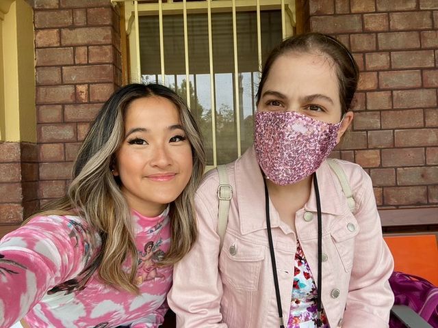 Two women dressed in pink take a selfie