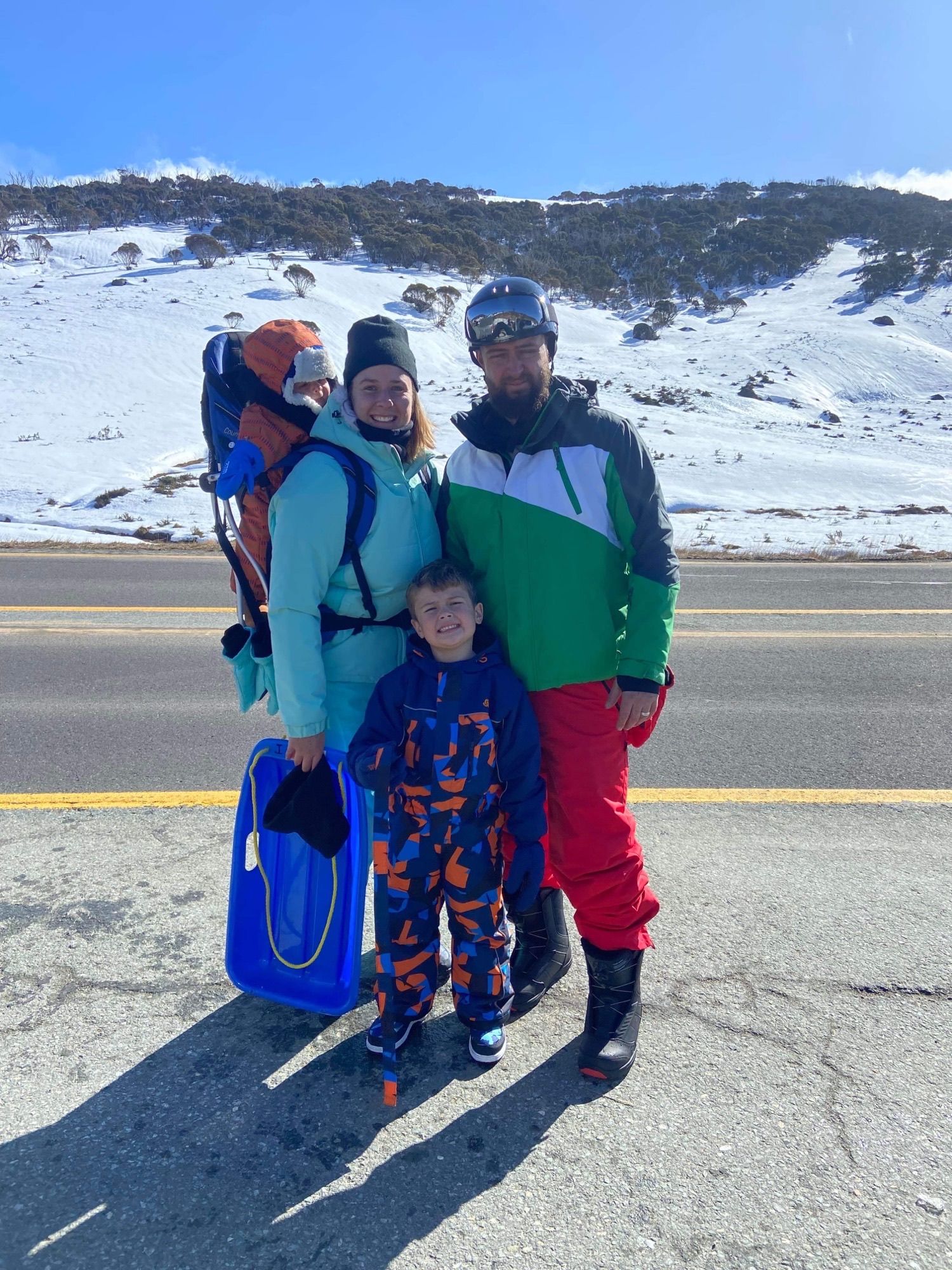 Jessica and her family wearing ski gear at the snow