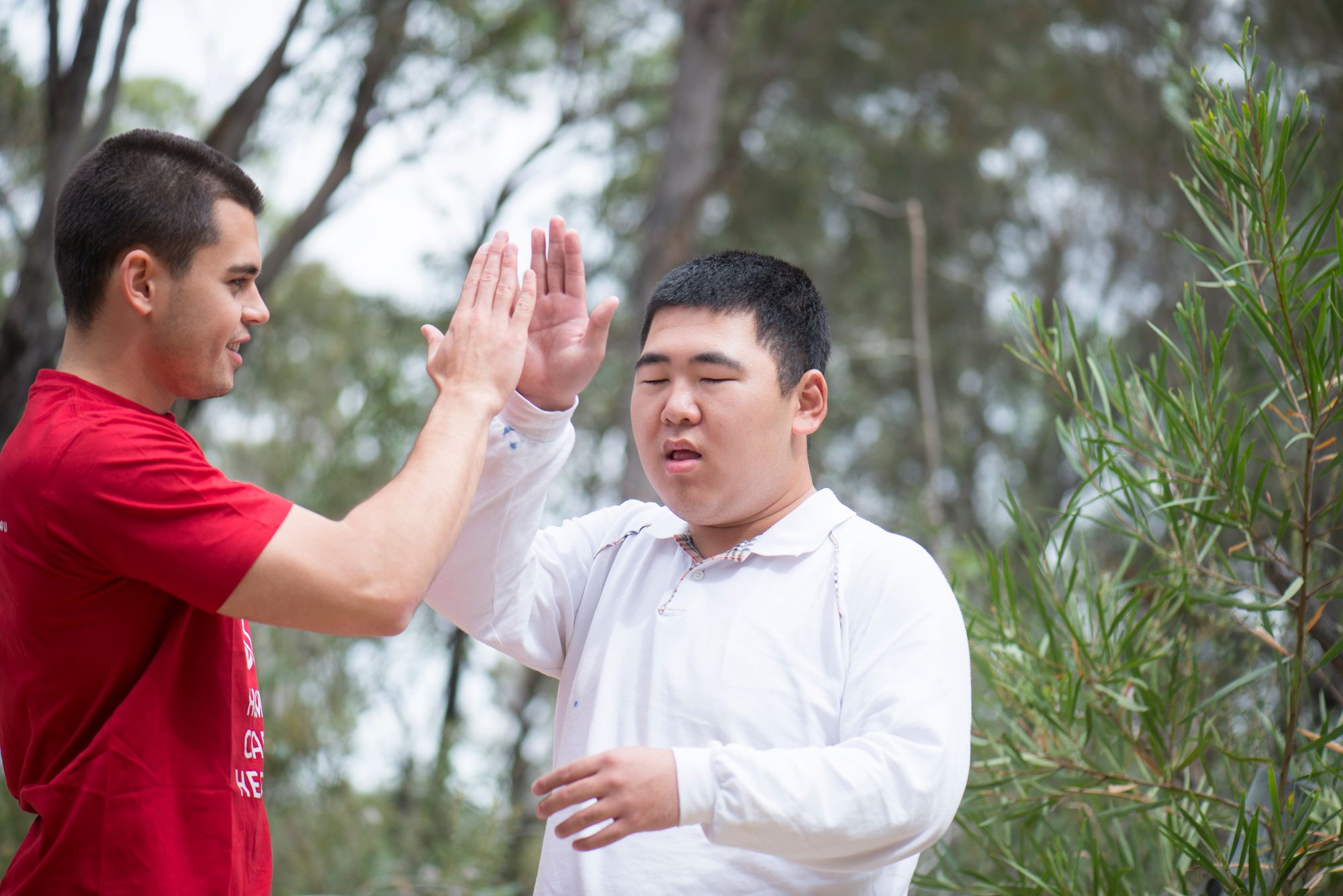 A support worker gives a man a high five