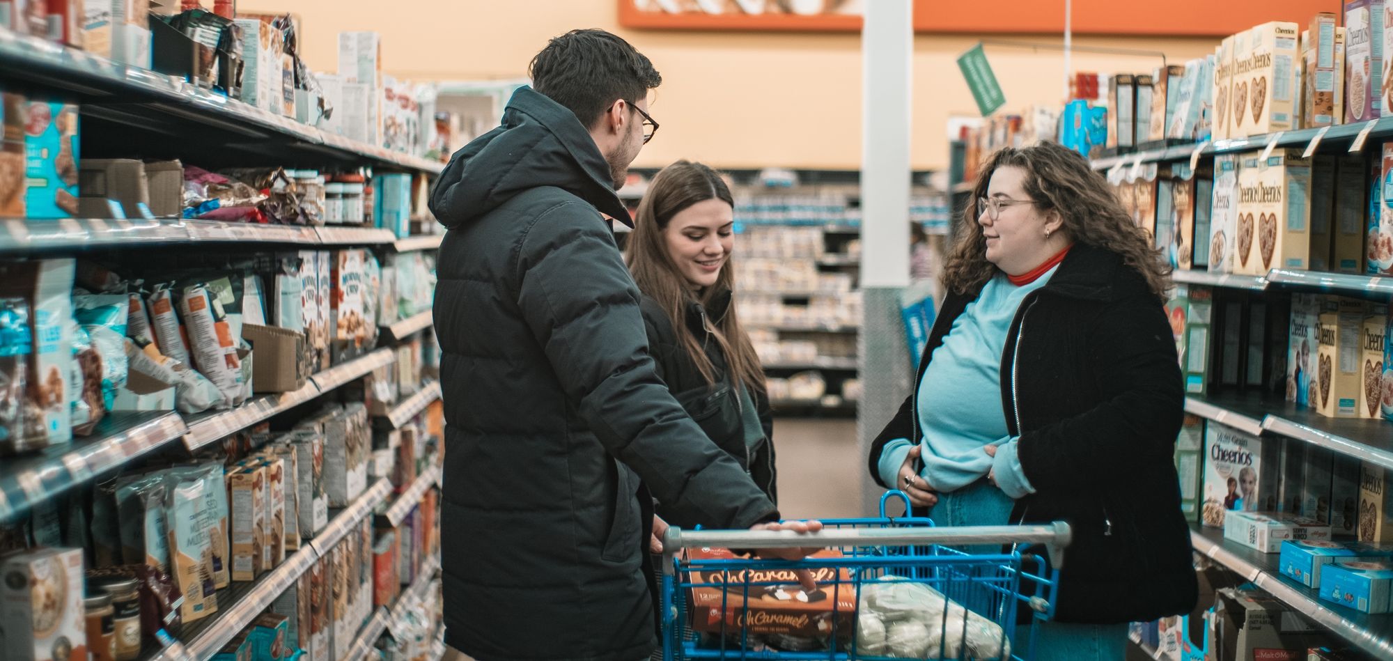 Three people grocery shopping together