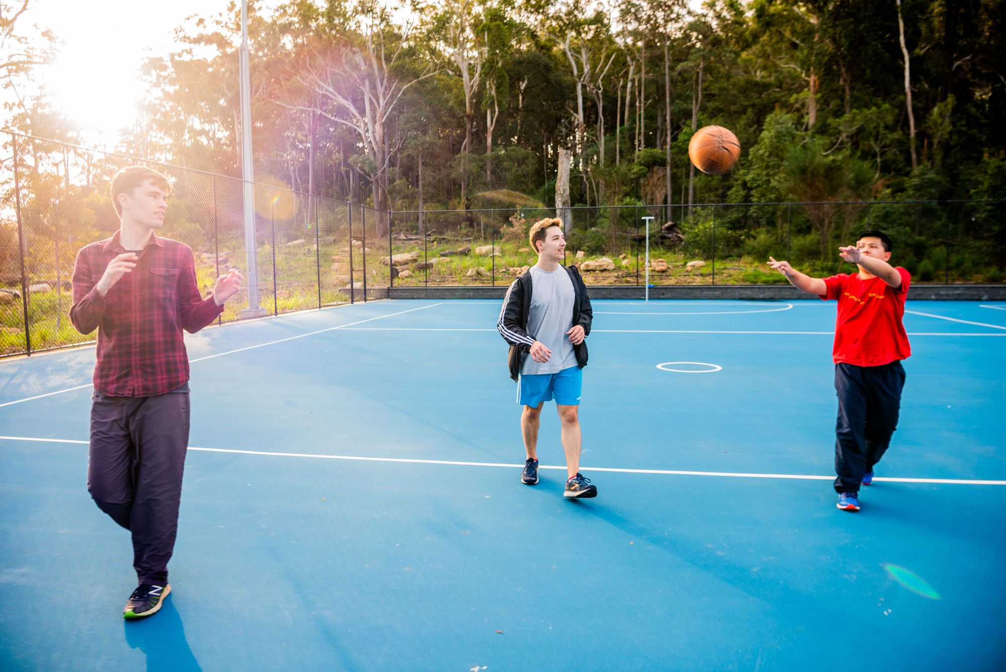 3 people playing basketball