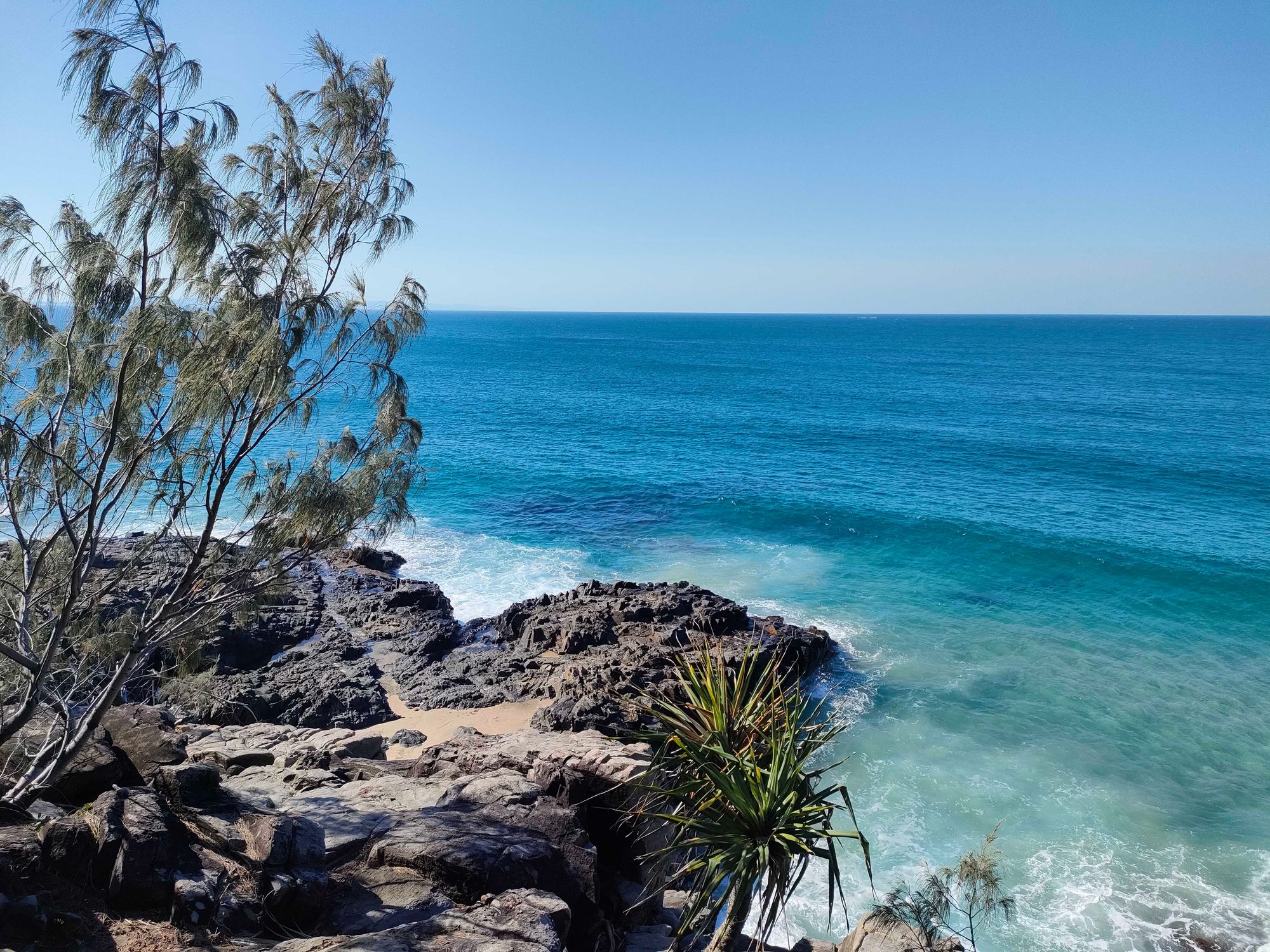 The rocks overlooking a crystal blue ocean