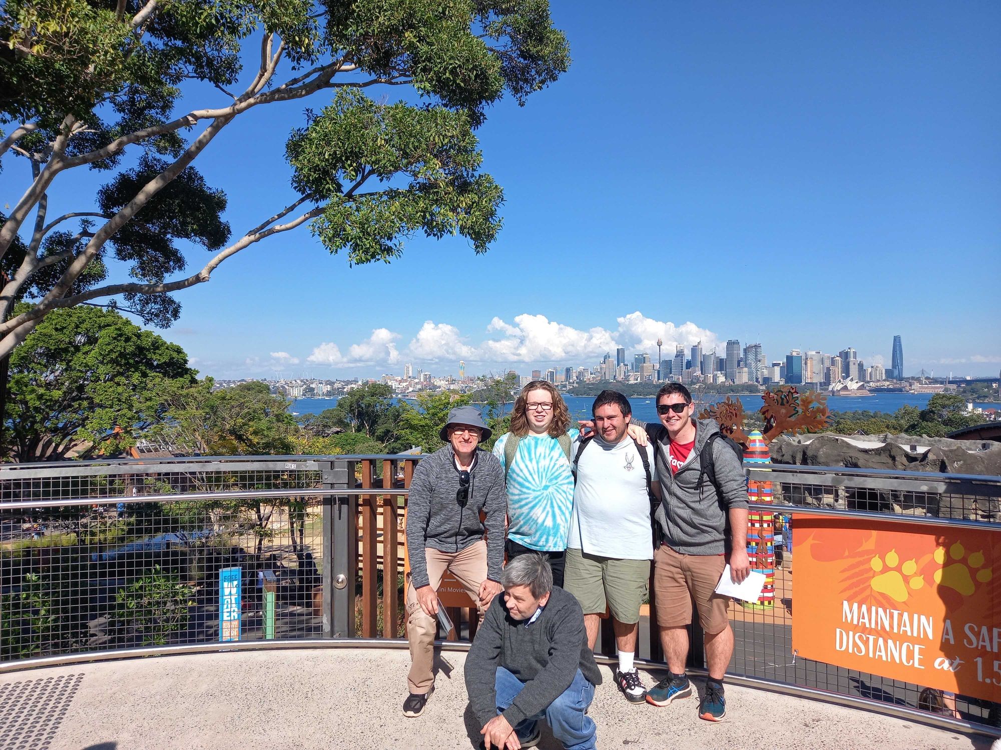 Group of men at Taronga Zoo, with views of the harbour behind them