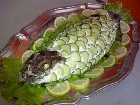 Fish decorated with cucumber slices and lemon