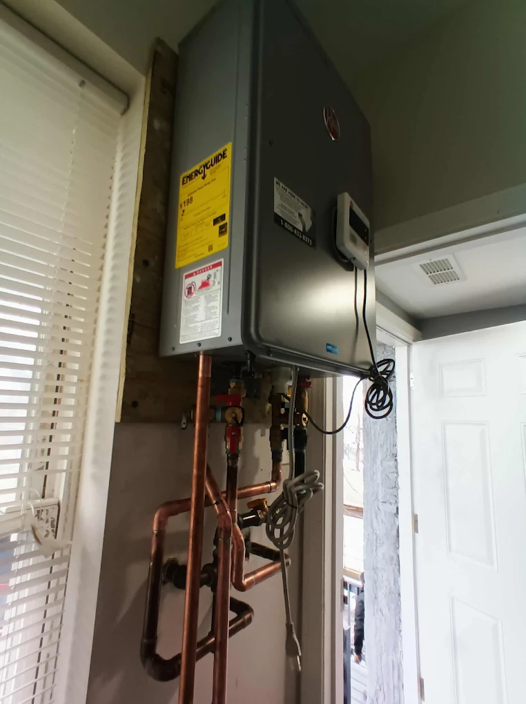 Modern tankless water heater installation with copper piping