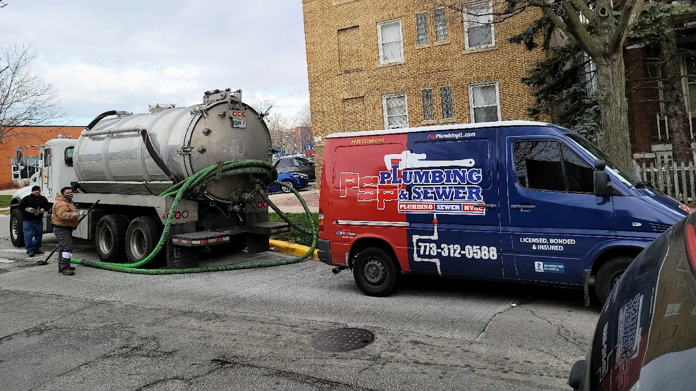 PSP Plumbing team with vacuum truck and service van performing a sewer service